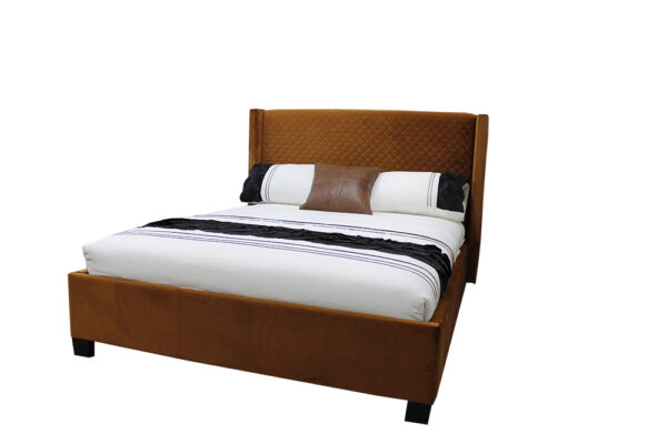 queen bed upholstered in rust cloured quilted velvet