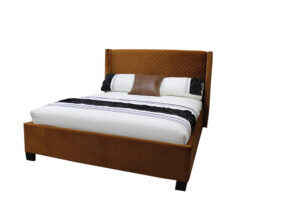 queen bed upholstered in rust cloured quilted velvet